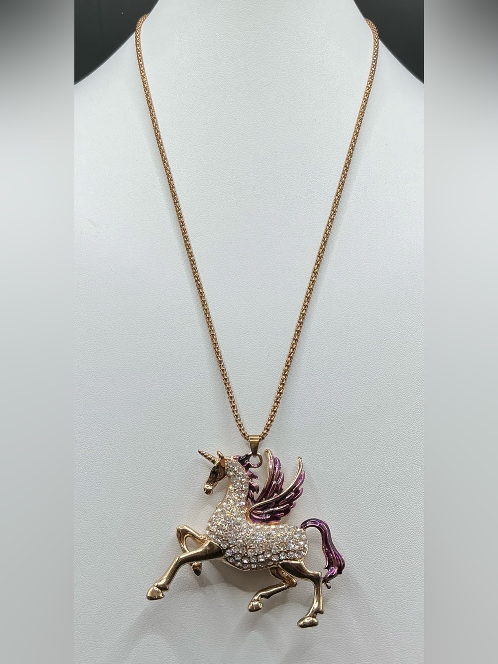 BETSEY JOHNSON GOLD TONE CRYSTAL UNICORN STATEMENT NECKLACE WITH PURPLE ACCENTS